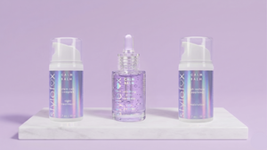 Three skincare products on a white platform with a purple background